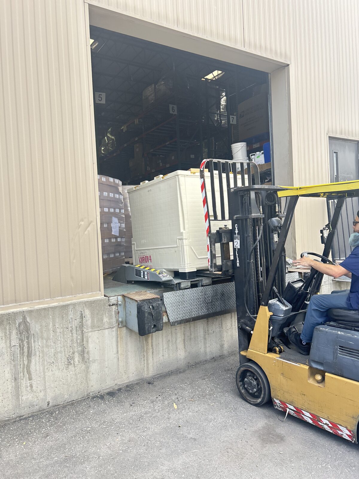 Forklift loading cargo at a warehouse dock